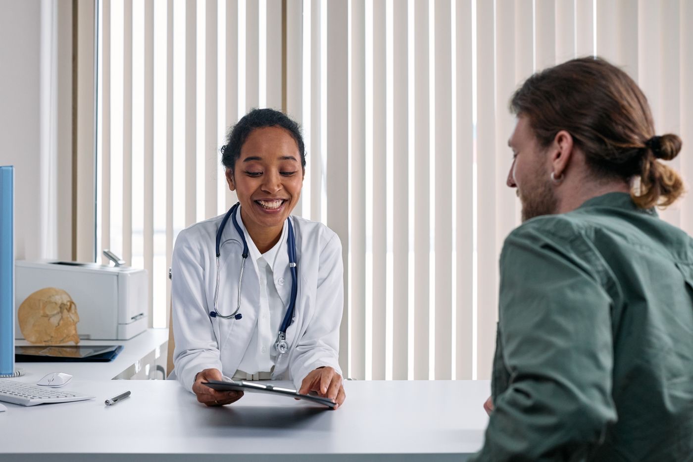 Clinician and patient reviewing information together during a consultation